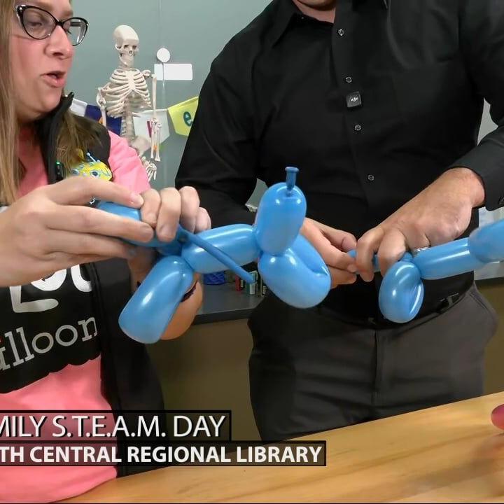 Keith Kaiser learns how to make animal balloons at Louisville's South Central Regional Library